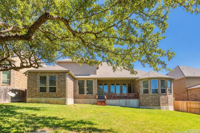 rear view of property with a lawn