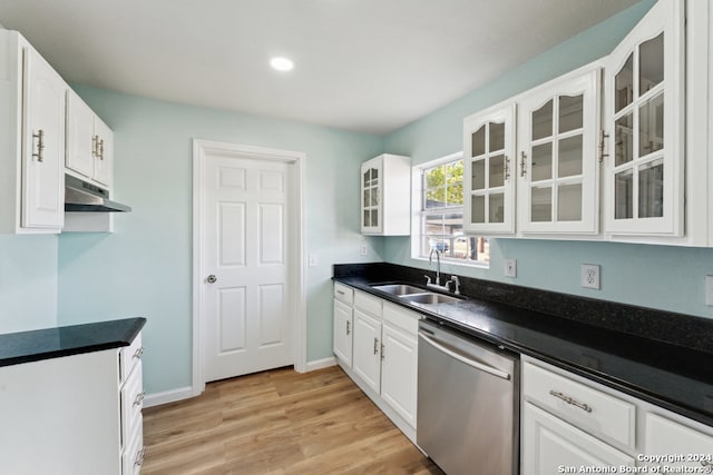 kitchen with stainless steel dishwasher, sink, white cabinetry, and light wood-type flooring