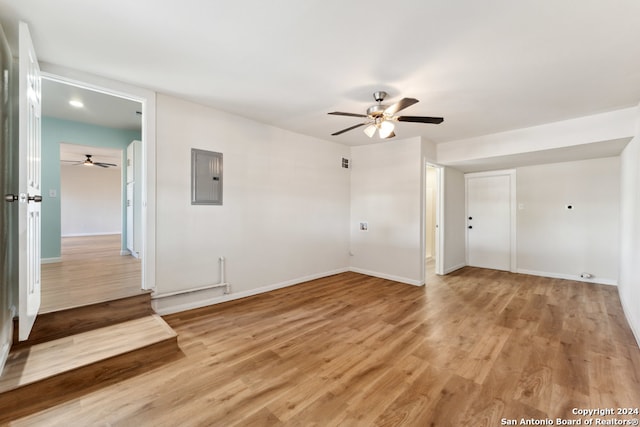 unfurnished room featuring electric panel and light wood-type flooring