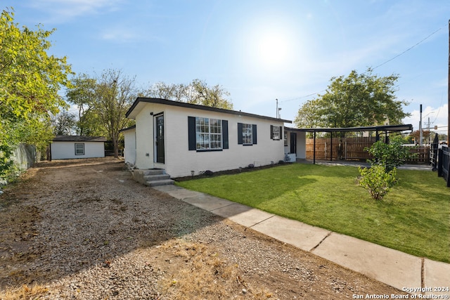 single story home with a front lawn and a carport