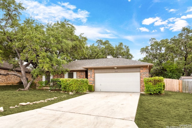 single story home with a front yard and a garage