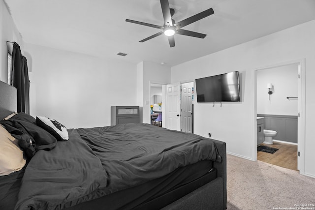 carpeted bedroom with connected bathroom and ceiling fan