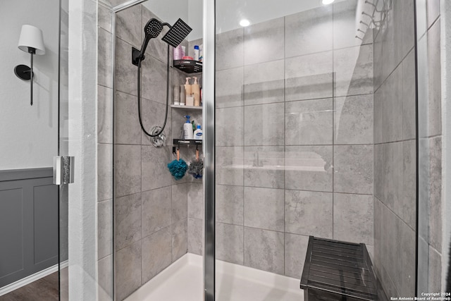 bathroom with a shower with door and hardwood / wood-style flooring