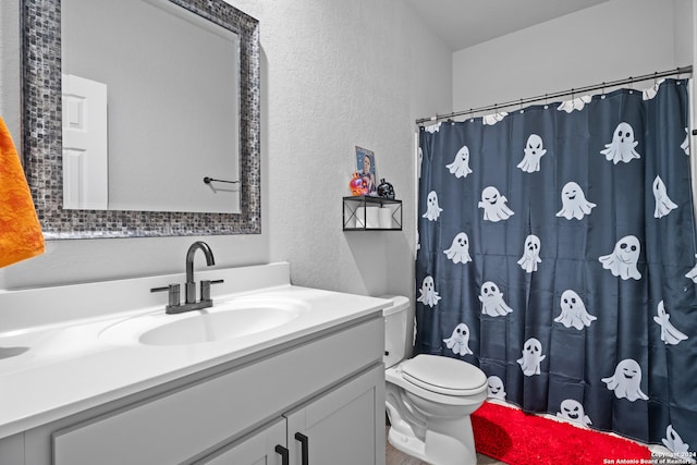 bathroom featuring vanity, toilet, and walk in shower