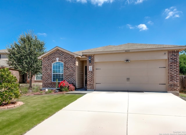 ranch-style home with a front lawn and a garage