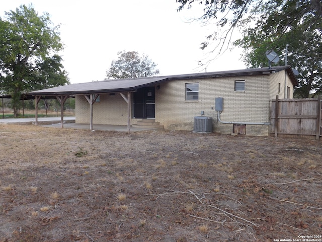 rear view of house with central AC unit