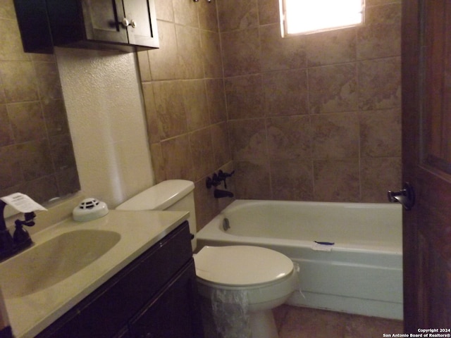 full bathroom with vanity, toilet, and tiled shower / bath combo