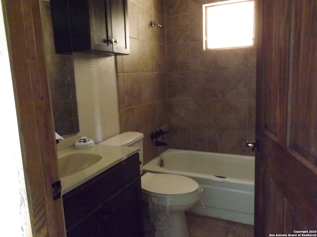 full bathroom with toilet, tiled shower / bath combo, and vanity