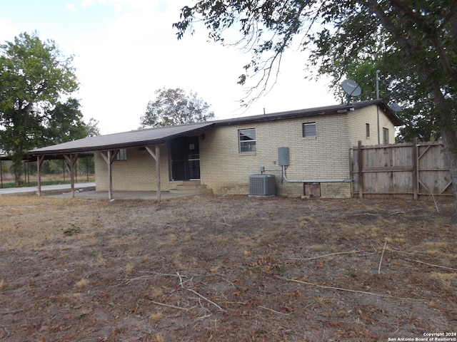 back of house with central air condition unit