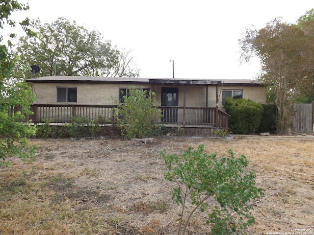 rear view of property with a wooden deck