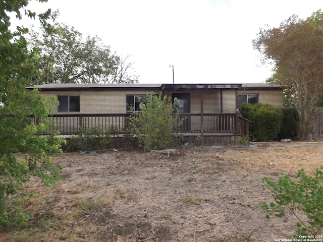 back of property featuring a wooden deck