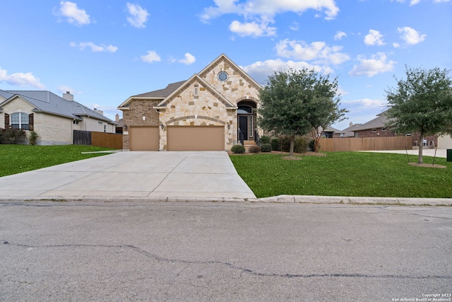 view of front of property featuring a garage and a front lawn