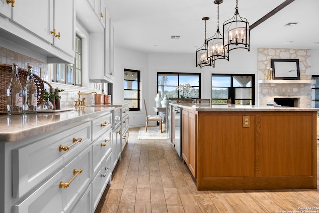 kitchen with white cabinets and an island with sink