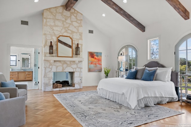 bedroom featuring light parquet flooring, a fireplace, beamed ceiling, connected bathroom, and high vaulted ceiling