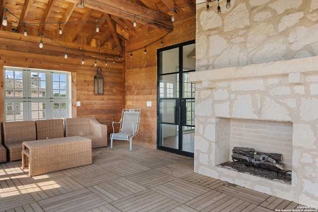 unfurnished living room with beamed ceiling, wood ceiling, and high vaulted ceiling