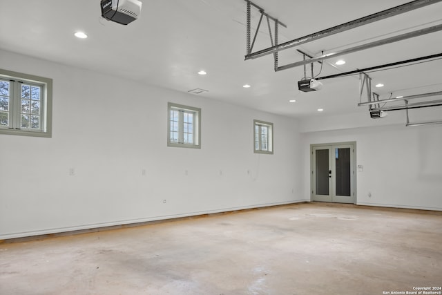 garage with french doors and a garage door opener