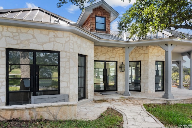 property entrance with a patio area and french doors