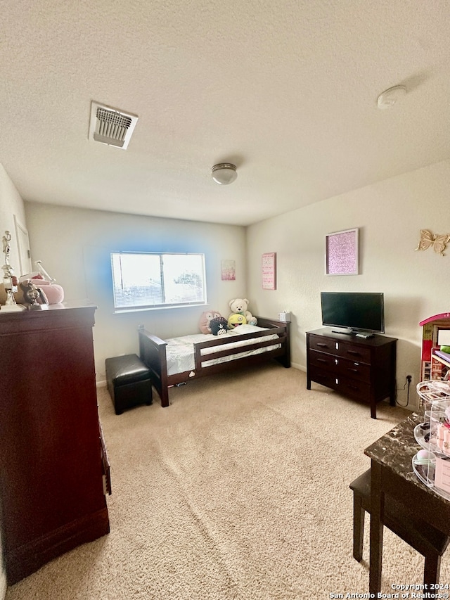 carpeted bedroom with a textured ceiling