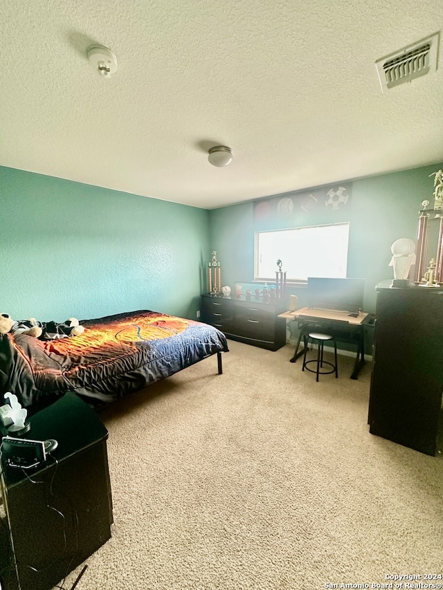 carpeted bedroom with a textured ceiling