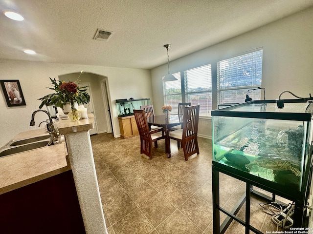 dining room with sink and a textured ceiling