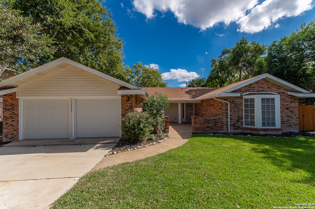 ranch-style home featuring a front yard and a garage