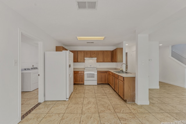 kitchen featuring white appliances, separate washer and dryer, sink, and light tile patterned flooring