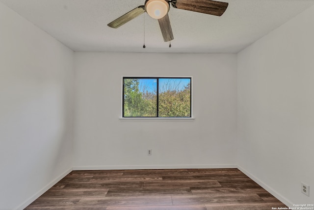 empty room featuring ceiling fan, dark hardwood / wood-style floors, and a textured ceiling