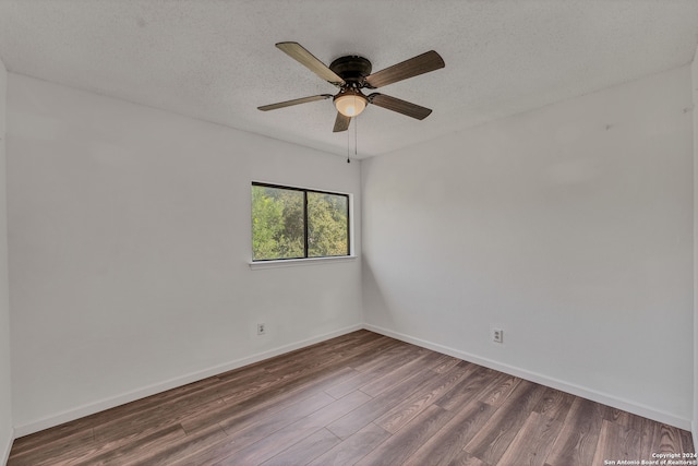 empty room with ceiling fan, dark hardwood / wood-style floors, and a textured ceiling