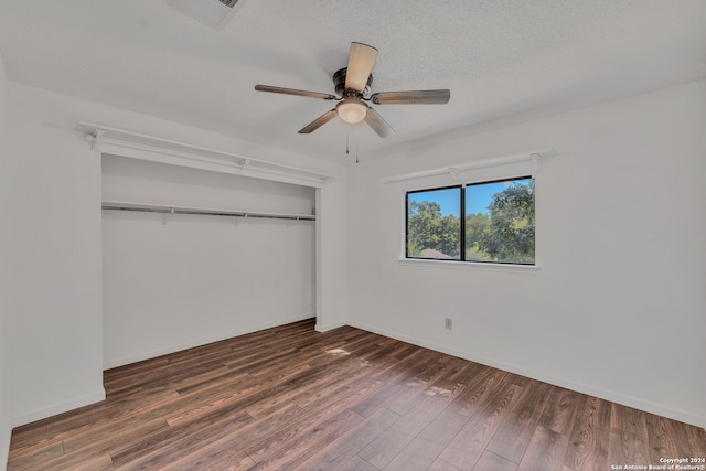 unfurnished bedroom with a closet, ceiling fan, a textured ceiling, and dark hardwood / wood-style floors