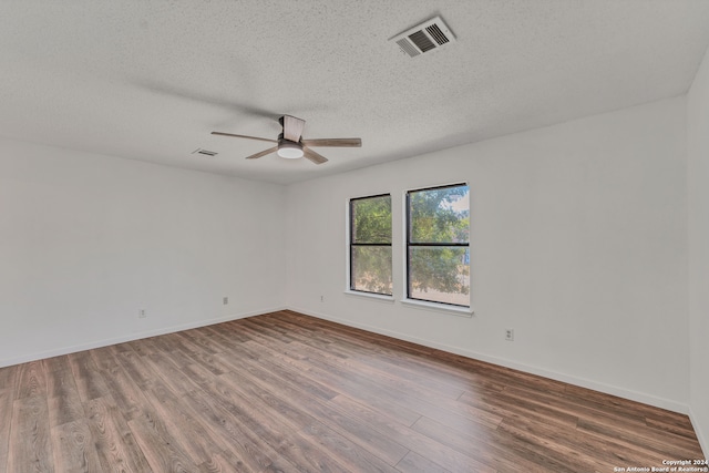 spare room with wood-type flooring, a textured ceiling, and ceiling fan