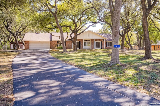 single story home with a front yard and a garage