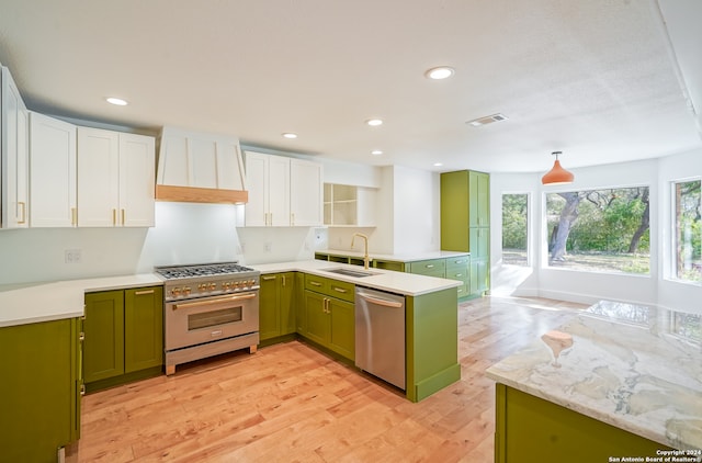 kitchen featuring sink, appliances with stainless steel finishes, light hardwood / wood-style flooring, and white cabinetry