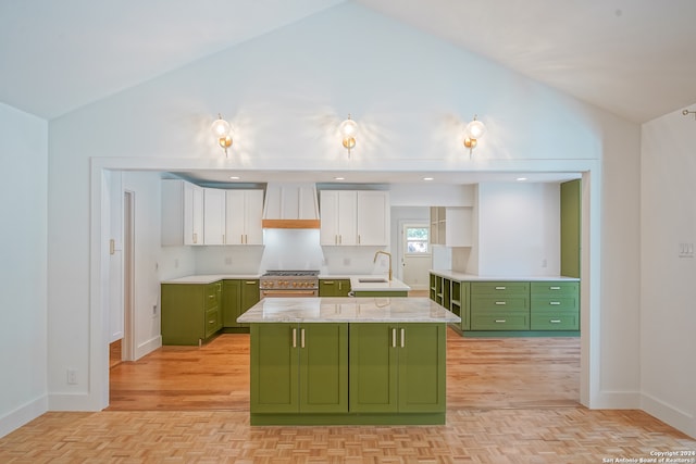 kitchen with vaulted ceiling, green cabinets, and white cabinets