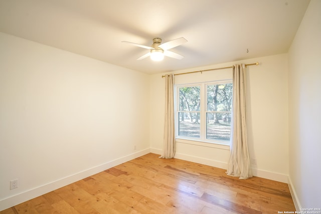 empty room featuring ceiling fan and light hardwood / wood-style flooring