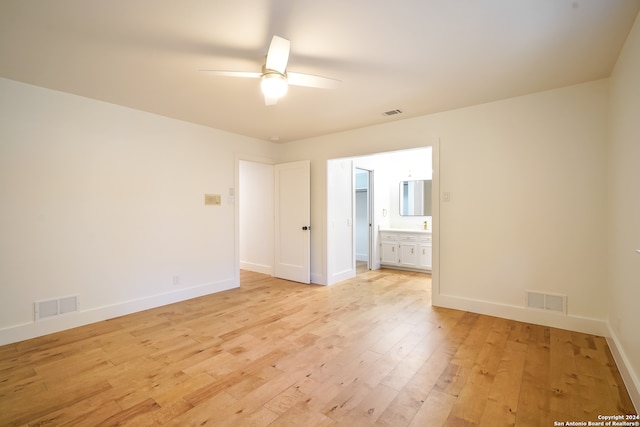 empty room featuring light wood-type flooring and ceiling fan