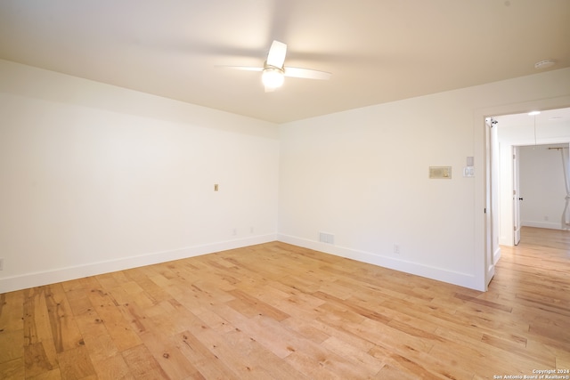 unfurnished room with light wood-type flooring and ceiling fan