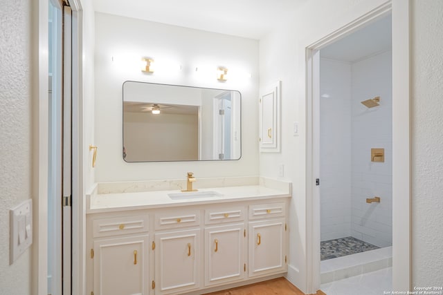 bathroom with vanity and a tile shower