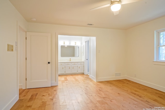 spare room featuring light hardwood / wood-style floors and ceiling fan