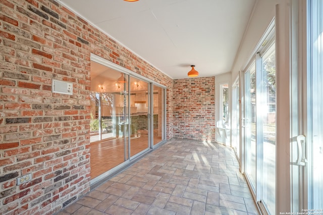 unfurnished sunroom featuring a healthy amount of sunlight