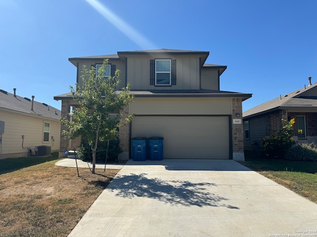 view of front of house with central AC and a garage