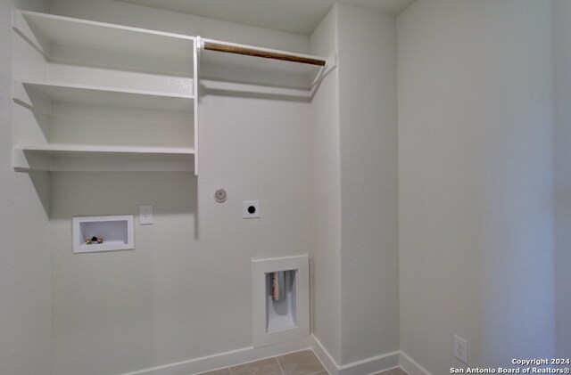 laundry room with hookup for a washing machine, light tile patterned floors, and electric dryer hookup