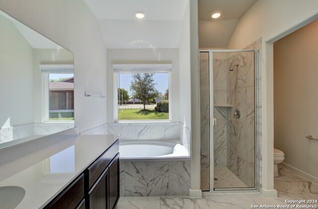 full bathroom with vanity, vaulted ceiling, shower with separate bathtub, and toilet