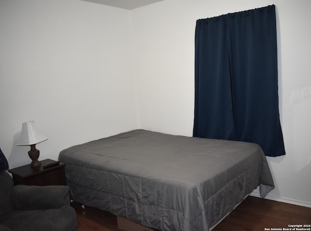 bedroom featuring dark hardwood / wood-style floors