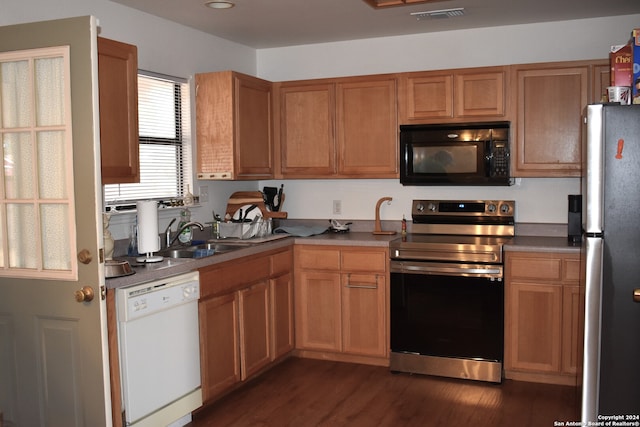 kitchen with sink, stainless steel appliances, and dark hardwood / wood-style floors