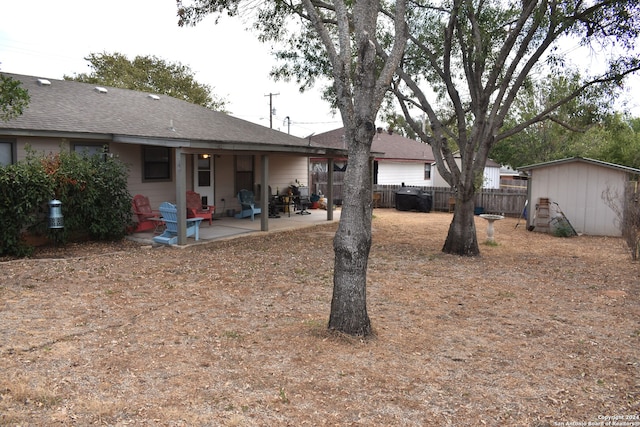 view of yard featuring a patio and a shed