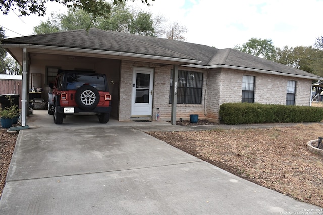 single story home featuring a carport