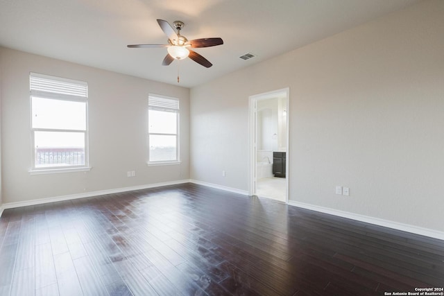 unfurnished room featuring dark hardwood / wood-style flooring, a healthy amount of sunlight, and ceiling fan