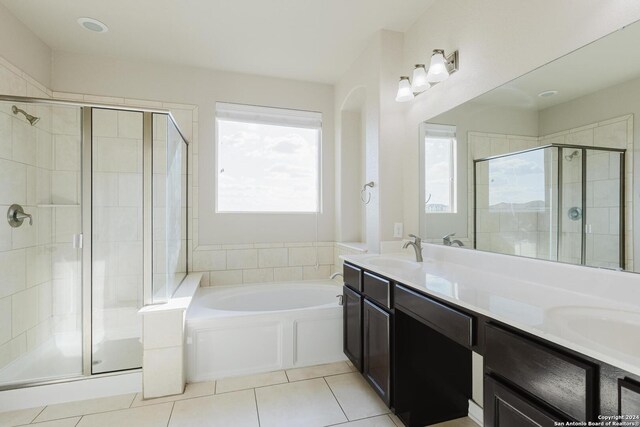 bathroom featuring vanity, tile patterned flooring, and separate shower and tub