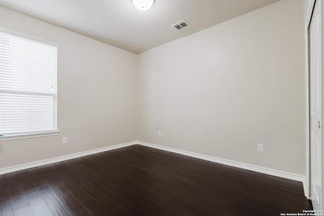 spare room with dark hardwood / wood-style flooring