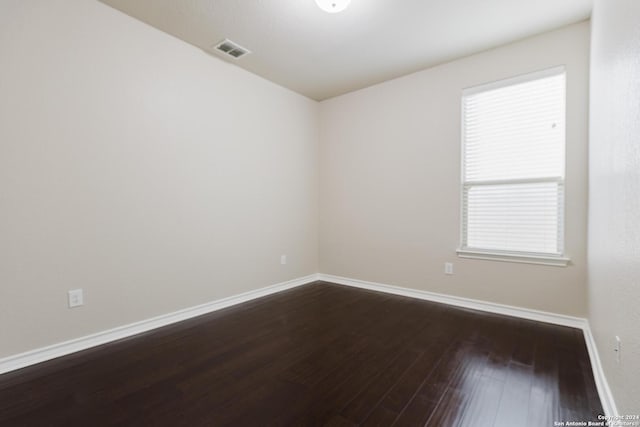 unfurnished room featuring hardwood / wood-style floors and a wealth of natural light